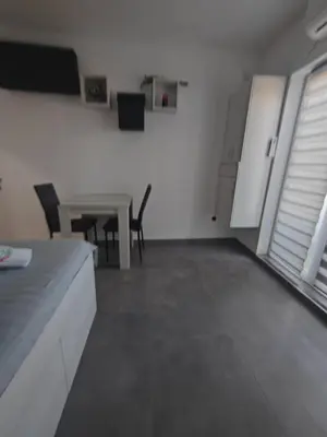 a living room with a table and a table and chairs at Apartman Iris in Vrnjačka Banja