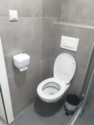 a bathroom with a white toilet in a stall at Apartman Iris in Vrnjačka Banja