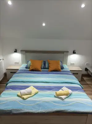 a large bed with two pillows on top of it at NiTex Studio in Soko Banja