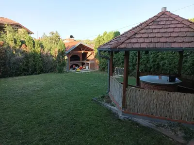 a gazebo with a table in a yard at NiTex Studio in Soko Banja