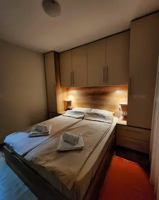 a bedroom with a bed with two towels on it at Apartman Minja in Vrnjačka Banja