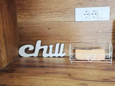 a wall with the word chill next to a towel rack at Apartman Minja in Vrnjačka Banja