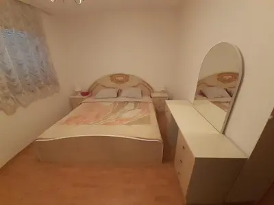 a small bedroom with a bed and a mirror at Nole 2 in Despotovac