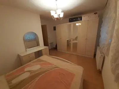 a room with a bedroom with a bed and a mirror at Nole 2 in Despotovac