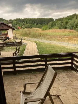 a chair sitting next to a wooden fence at MIN apartman Goc in Vrnjačka Banja