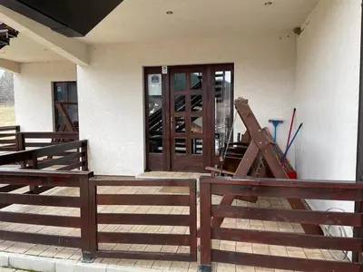 a house with a wooden door and a wooden fence at MIN apartman Goc in Vrnjačka Banja