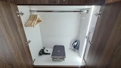 an open door to a room with a chair in it at Hotel Sunčana planina - Wellness & Spa - Kopaonik - Sunny Mountain Apartments in Kopaonik