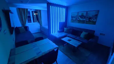 a living room with a couch and a table at Hotel Sunčana planina - Wellness & Spa - Kopaonik - Sunny Mountain Apartments in Kopaonik