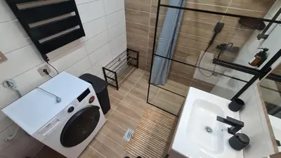 a bathroom with a washing machine and a sink at Hotel Sunčana planina - Wellness & Spa - Kopaonik - Sunny Mountain Apartments in Kopaonik