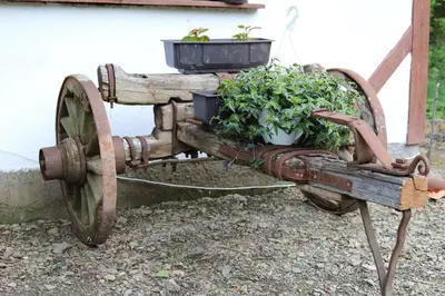 an old tractor with two potted plants on it at Sljivik in Niš