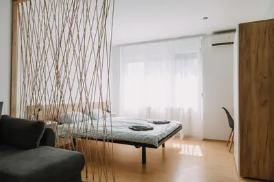 a room with a bed and a couch and a window at Constantin Inn in Niš