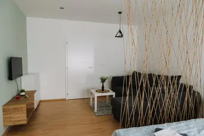 a living room with a couch and a tv at Constantin Inn in Niš