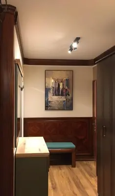 a room with a bench and a painting on the wall at Lux Apartman Holiday-Brzeće, Kopaonik in Brzeće