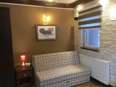 a living room with a couch and a window at Lux Apartman Holiday-Brzeće, Kopaonik in Brzeće