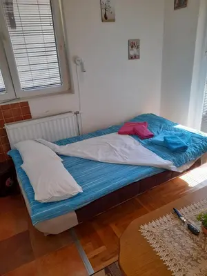 a unmade bed in a room with a window at N&N in Brzeće