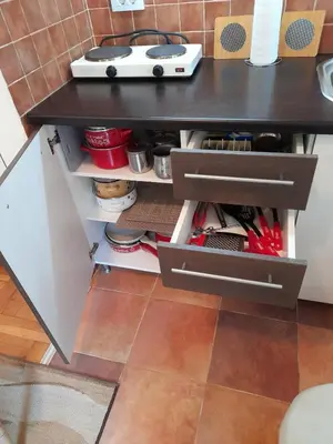 a kitchen island with drawers and a table at N&N in Brzeće