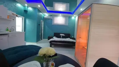 a living room with a couch and a table with flowers at Apartman Melody in Paraćin