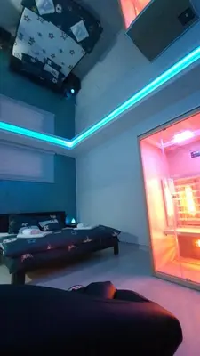 a room with a bed and a window with lights at Apartman Melody in Paraćin