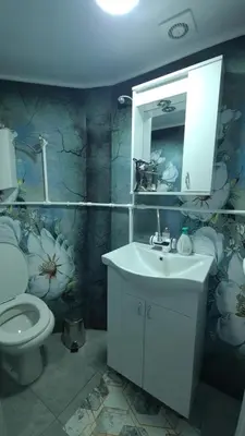 a bathroom with a white sink and a toilet at Apartman Melody in Paraćin