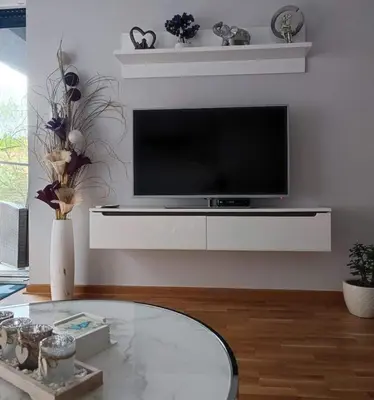a living room with a tv and a table at Apartman MAJA in Vrnjačka Banja