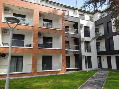 an apartment building with balconies and a lawn at Apartman MAJA in Vrnjačka Banja
