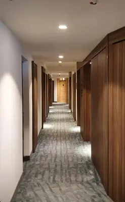 a hallway of a hotel with a long corridor of rooms at Select Woodside Residence & Spa in Kopaonik