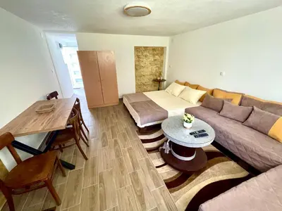 a living room with a couch and a bed at Apartmani Stanković Sokobanja in Soko Banja