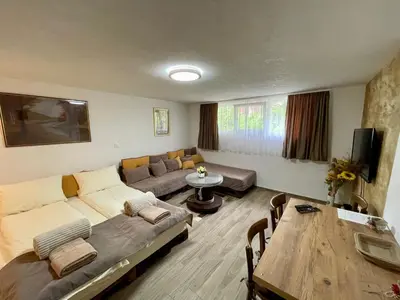 a living room with a couch and a table at Apartmani Stanković Sokobanja in Soko Banja