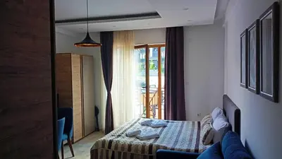 a bedroom with a bed and a window with a patio at Kopaonik Bliss in Kopaonik