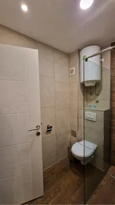 a bathroom with a toilet and a glass door at Kopaonik Bliss in Kopaonik