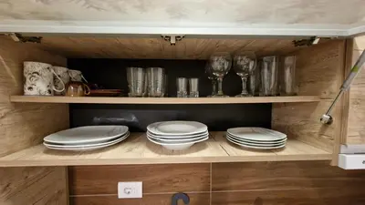 a cupboard with plates and dishes on it at Kopaonik Bliss in Kopaonik