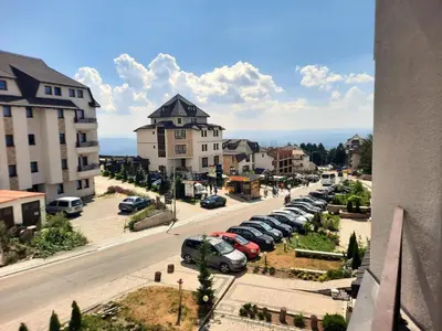a city street with cars parked in a parking lot at Kopaonik Bliss in Kopaonik