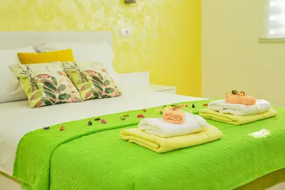two towels with cats on them on a bed at Apartmani Milenkovic in Soko Banja