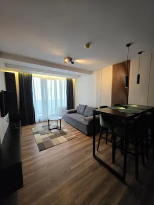 a living room with a couch and a table at SkyKop Apartmani in Kopaonik