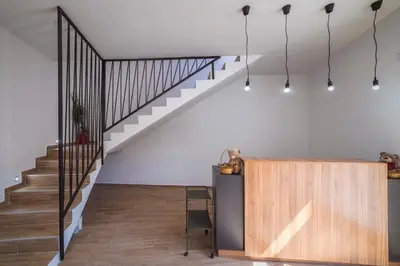 a staircase in a home with white walls and wood floors at Zoe Pirot in Pirot
