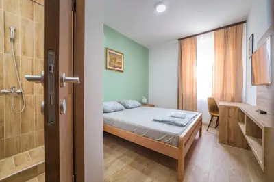 a small bedroom with a bed and a bathroom at Zoe Pirot in Pirot