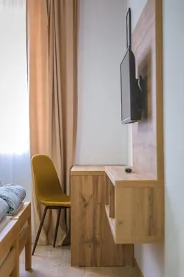 a bedroom with a desk with a tv and a chair at Zoe Pirot in Pirot