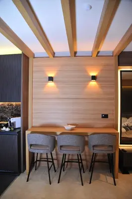 a dining room with a wooden table and chairs at Family Apart Woodside in Kopaonik