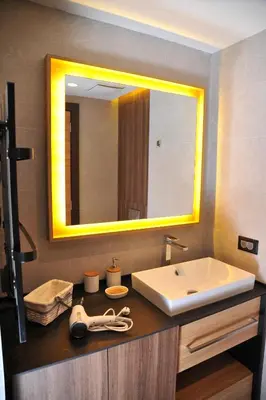 a bathroom with a sink and a large mirror at Family Apart Woodside in Kopaonik