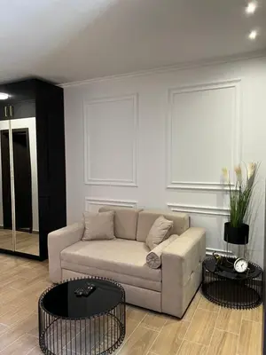 a living room with a couch and two tables at MVP Apartment Kopaonik in Kopaonik