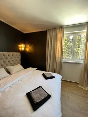 a bedroom with a large bed with a tray on it at MVP Apartment Kopaonik in Kopaonik