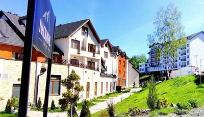 a street sign in front of a group of buildings at Milmari-Kopaonik in Kopaonik
