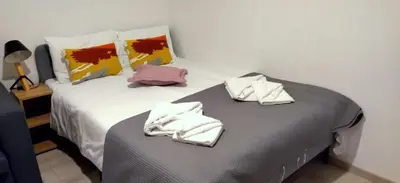 a bedroom with a bed with two towels on it at Milmari-Kopaonik in Kopaonik