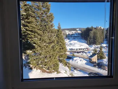 a window with a view of a snow covered mountain at Rajski kutak - Centar in Kopaonik