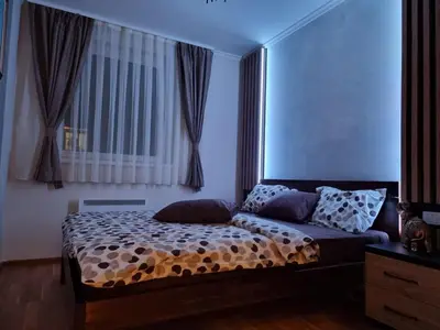 a bedroom with a bed and a window at Rajski kutak - Centar in Kopaonik