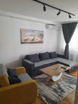 a living room with a couch and a coffee table at Holiday apartaments 2 in Niš