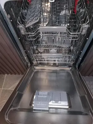 a dishwasher filled with lots of dishes at Woodside Kopaonik by Ister in Kopaonik