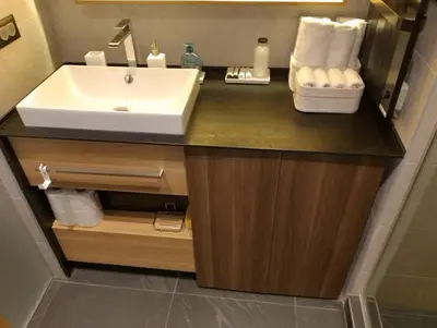 a bathroom with a sink and a counter with towels at Woodside Kopaonik by Ister in Kopaonik