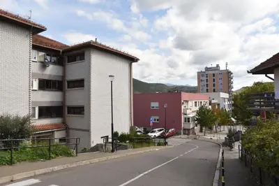 an empty street in a city with buildings at Stan Na Dan Central Park in Raška