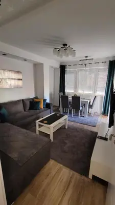 a living room with a couch and a table at Stan Na Dan Central Park in Raška